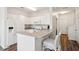 White kitchen with breakfast bar, stainless steel appliances, and granite countertops at 130 River Landing Dr # 8203, Charleston, SC 29492