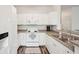 White kitchen with stainless steel appliances and granite countertops at 130 River Landing Dr # 8203, Charleston, SC 29492