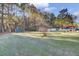 Large backyard with green grass and trees at 1401 Churchill Rd, Moncks Corner, SC 29461
