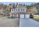 Two-story house with brick and siding, two-car garage, and a porch at 1401 Churchill Rd, Moncks Corner, SC 29461