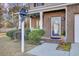 Brick front porch with a blue door and decorative bell at 1401 Churchill Rd, Moncks Corner, SC 29461