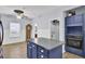 Eat-in kitchen with blue cabinets, island, and access to back yard at 1401 Churchill Rd, Moncks Corner, SC 29461