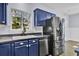 Kitchen with blue cabinets, stainless steel appliances, and a farmhouse sink at 1401 Churchill Rd, Moncks Corner, SC 29461