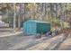 Green metal storage shed with double doors and ramp at 1401 Churchill Rd, Moncks Corner, SC 29461