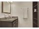 Bathroom with dark vanity, granite countertop, and shelving at 15 Horlbeck Aly # A-7, Charleston, SC 29401