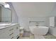 Clean bathroom with a freestanding tub and tiled walls at 15 Horlbeck Aly # A-7, Charleston, SC 29401