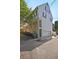 Side view of townhome showcasing white exterior, green shutters, and a garage at 15 Horlbeck Aly # A-7, Charleston, SC 29401