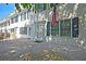Townhome's entrance with green shutters, American flag, and patio at 15 Horlbeck Aly # A-7, Charleston, SC 29401