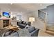 Bright living room with fireplace, comfy sofas, and kitchen view at 15 Horlbeck Aly # A-7, Charleston, SC 29401