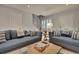 Living area with two sofas, coffee table, and view of staircase at 15 Horlbeck Aly # A-7, Charleston, SC 29401