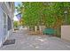 Peaceful patio with green bench, American flag, and lush greenery at 15 Horlbeck Aly # A-7, Charleston, SC 29401