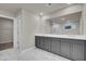 Double vanity bathroom with grey cabinets and marble floors at 2018 Quiet Ibis Rd, Hanahan, SC 29410
