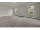 Large bedroom with grey carpeting and two windows at 2018 Quiet Ibis Rd, Hanahan, SC 29410