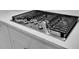 Stainless steel gas cooktop with black grate and white countertop at 2018 Quiet Ibis Rd, Hanahan, SC 29410