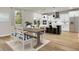 Kitchen and dining area with hardwood floors and farmhouse style table at 2018 Quiet Ibis Rd, Hanahan, SC 29410