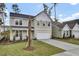 Two-story house with gray siding, white garage door, and palm tree in front at 2018 Quiet Ibis Rd, Hanahan, SC 29410