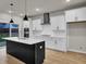 Modern kitchen with white cabinets, quartz countertops, and large island at 2018 Quiet Ibis Rd, Hanahan, SC 29410