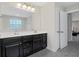 Double vanity bathroom with dark brown cabinets at 440 Coopers Hawk Dr, Summerville, SC 29483