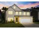 Two story house with lights on at dusk at 440 Coopers Hawk Dr, Summerville, SC 29483