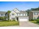 Two-story house with a white garage door and landscaping at 440 Coopers Hawk Dr, Summerville, SC 29483