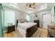 Spacious primary bedroom with wood flooring, large bed, and plenty of natural light at 4858 Marshwood Dr, Hollywood, SC 29449