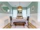 Bright dining area with green walls, wood floors, and a farmhouse style table at 4858 Marshwood Dr, Hollywood, SC 29449