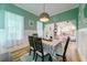Charming dining room with green walls and a checkered tablecloth on the table at 4858 Marshwood Dr, Hollywood, SC 29449