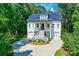 Two-story home with metal roof, green accents, and a circular driveway at 4858 Marshwood Dr, Hollywood, SC 29449