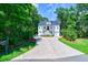 Two story home with welcoming front porch and landscaped yard at 4858 Marshwood Dr, Hollywood, SC 29449