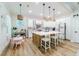 Open concept kitchen featuring white cabinets, kitchen island, and hardwood floors at 4858 Marshwood Dr, Hollywood, SC 29449