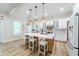 Bright kitchen with white cabinets, large island, and stainless steel appliances at 4858 Marshwood Dr, Hollywood, SC 29449
