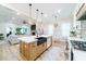 Modern kitchen with a farmhouse sink, breakfast bar, and views into the living room at 4858 Marshwood Dr, Hollywood, SC 29449