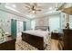 Spacious bedroom with a king-size bed, barn door to en-suite bathroom, and ceiling fan at 4858 Marshwood Dr, Hollywood, SC 29449
