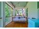 Relaxing screened porch with a hanging daybed and string lights at 4858 Marshwood Dr, Hollywood, SC 29449