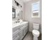 Clean bathroom with gray vanity, white toilet and tiled floor at 5344 Sea Watch Lane, North Charleston, SC 29406
