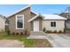 Modern stucco home with a unique roofline, landscaped yard, and a two-toned exterior at 5344 Sea Watch Lane, North Charleston, SC 29406