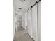 Bright hallway with tiled floor and white barn door at 5344 Sea Watch Lane, North Charleston, SC 29406