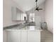 Modern kitchen with gray cabinets, granite countertops, and tile flooring at 5344 Sea Watch Lane, North Charleston, SC 29406