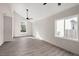 Open concept living room with hardwood floors, two windows, and ceiling fans at 5344 Sea Watch Lane, North Charleston, SC 29406