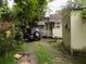 Backyard with Jeep, small shed, and overgrown vegetation at 571 Main Rd, Johns Island, SC 29455