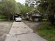 One-story house with carport and a white car at 571 Main Rd, Johns Island, SC 29455