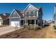 Two-story house with blue siding, white garage door, and a landscaped yard at 602 Yellow Leaf Ln, Summerville, SC 29486