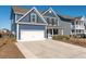 Two-story home with blue siding, white garage door, and driveway at 602 Yellow Leaf Ln, Summerville, SC 29486