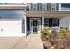 Front entry with black door, white columns, and landscaping at 602 Yellow Leaf Ln, Summerville, SC 29486