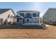 Two-story home with a screened porch, patio, pergola, and fire pit in the backyard at 602 Yellow Leaf Ln, Summerville, SC 29486