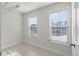 Bright laundry room features tile flooring, two large windows, and a ceiling clothes drying rack at 602 Yellow Leaf Ln, Summerville, SC 29486