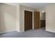 Simple bedroom with gray carpeting, double doors, and access to a hallway at 6240 April Pine Cir # B, North Charleston, SC 29406