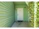 Private condo entry with white door and green walls, lush foliage at 6240 April Pine Cir # B, North Charleston, SC 29406