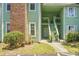 Condo building entrance with stairs and well-manicured landscaping at 6240 April Pine Cir # B, North Charleston, SC 29406