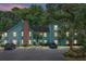 Evening view of a charming two-story light green building with ample parking at 6240 April Pine Cir # B, North Charleston, SC 29406